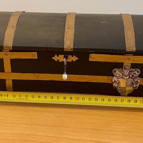 Antique wooden chest used with medieval emblem