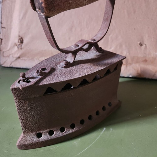 Charcoal iron used, traditional cast iron with wooden handle