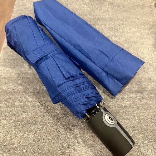 Blue folding umbrella branded with NIKMI AD new