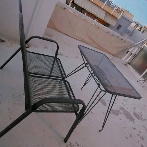 Metal double sofa and glass table used for garden or terrace