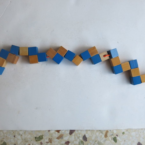 Wooden snake puzzle like new that transforms into a cube