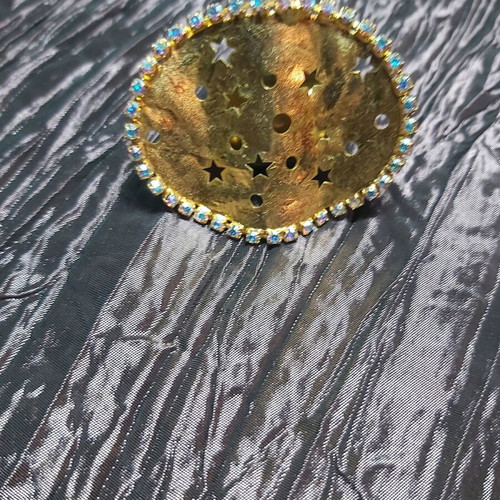 Large ring used, gold color with small strass