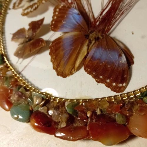 Vintage framed art with colorful stones and butterflies