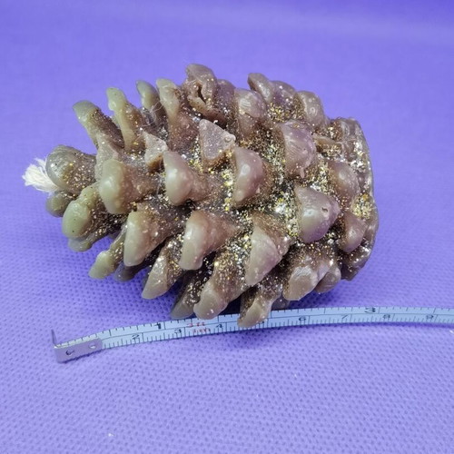 Decorative candle in pine cone shape like new