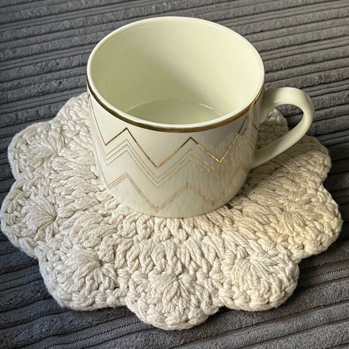 Knitted coaster used, flower-shaped, beige