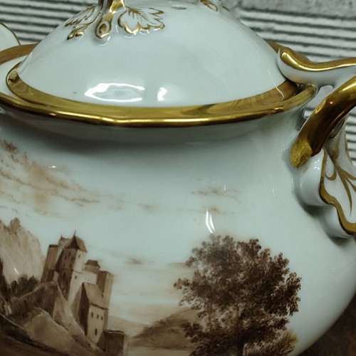 Antique porcelain teapot with wooden handle used