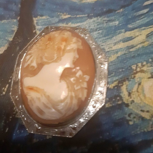 Vintage brooch like new with silver frame and carved bone relief