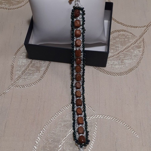 Handmade bracelet with brown wooden and green glass beads
