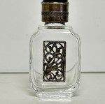 Vintage glass perfume bottle with metal decoration