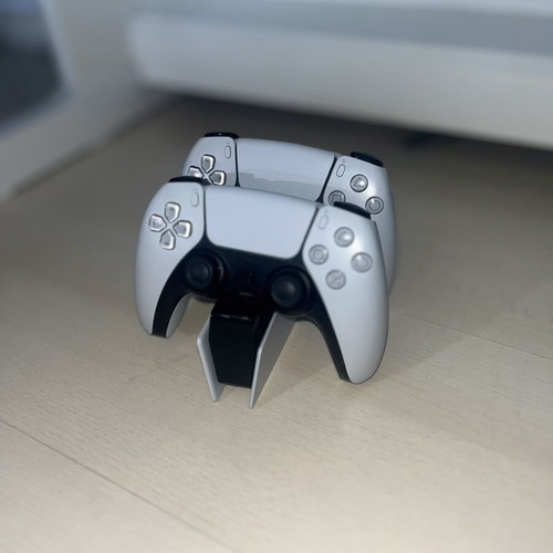 PlayStation 5 console used with two Assassin’s Creed games and DualSense controllers