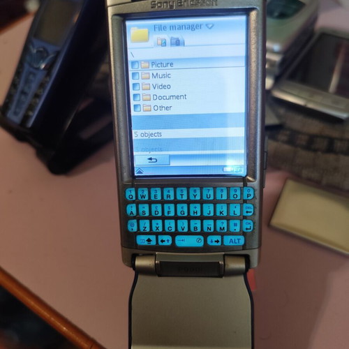 Sony Ericsson P990i vintage cell phone used with charger