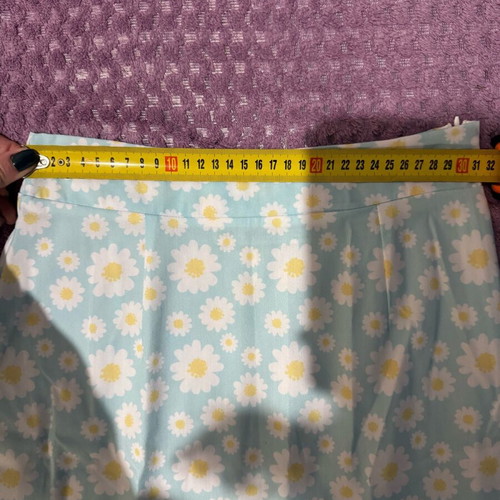 Mini skirt with daisies on blue background, size S, like new