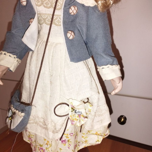 Porcelain doll rare, new with hat and dress