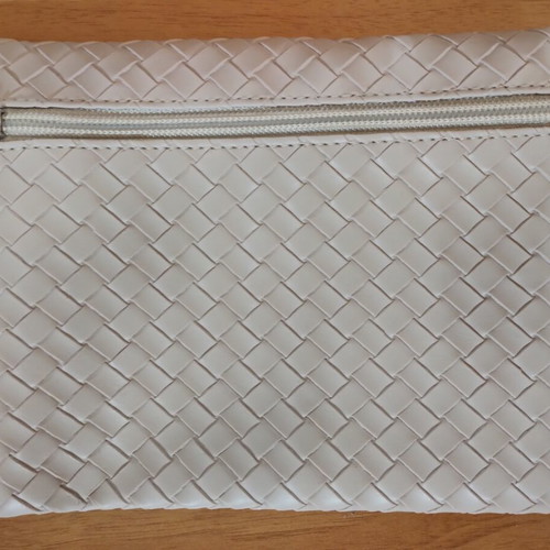 Everyday beige toiletry bag with woven texture and Versace Eros Pour Femme perfume sample