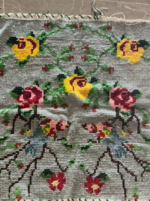 Handmade vintage cross-stitch embroidery with floral birds and roses