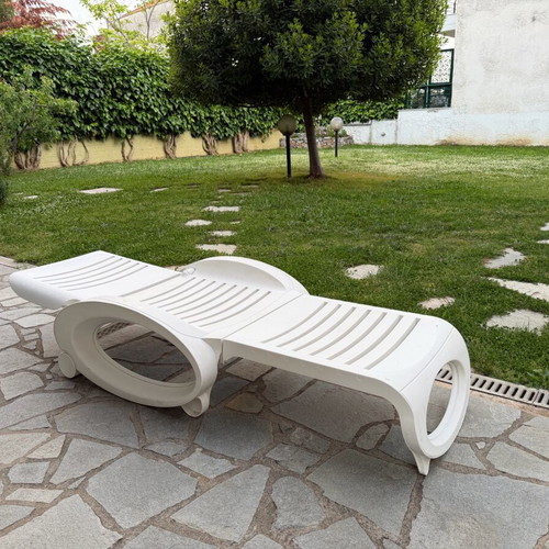 Plastic sun lounger used with wheels and adjustable backrest