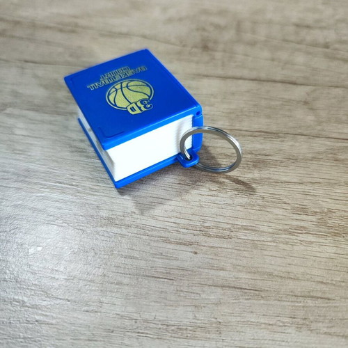 3D book keychain like new that turns into a basketball court blue