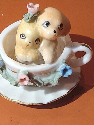Porcelain miniature dog and cat in cup