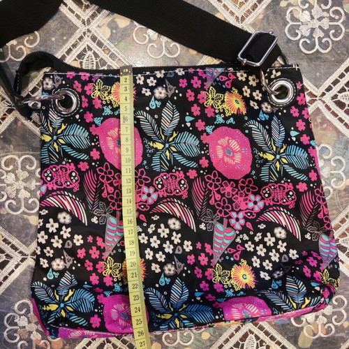 Crossbody fabric bag with colorful floral pattern, black background