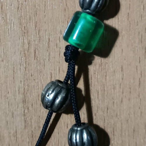 Worry beads used with green translucent beads and metal details