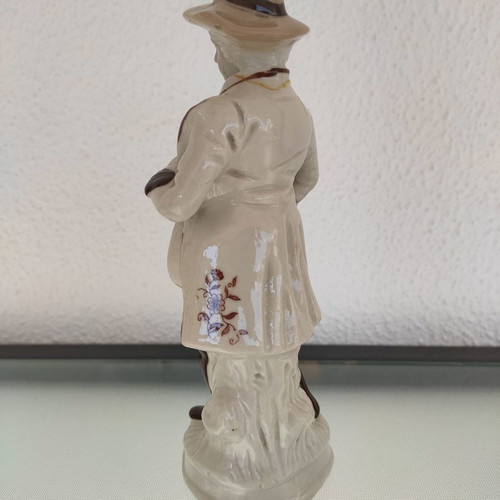 Porcelain decorative figure of man used with musical instrument