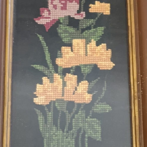 Vintage handmade embroidered textile painting in frame with glass