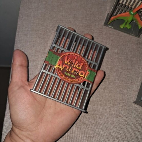 Dinosaur figures used, set in cages