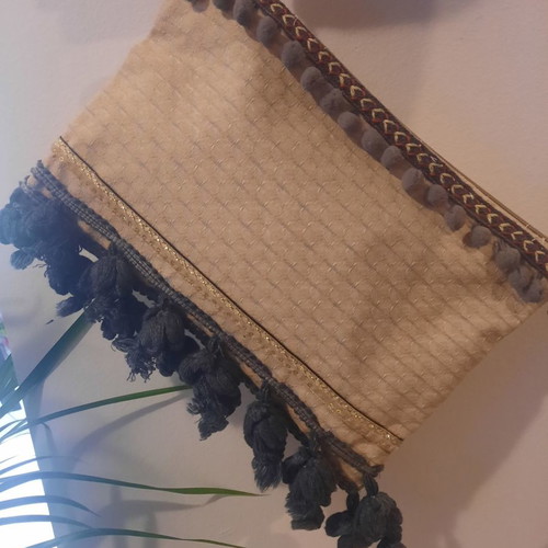 Handmade handbag used with gray tassels and golden details