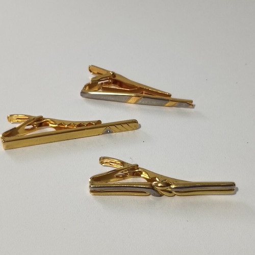 Tie clip used, gold color with silver accents