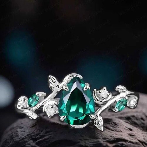 14K White Gold Engagement Ring with Emerald and Moissanite