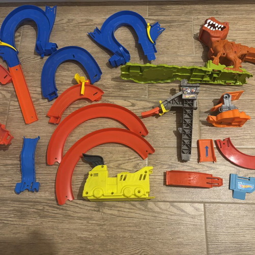 Hot Wheels track set pieces with T-Rex figure and launcher