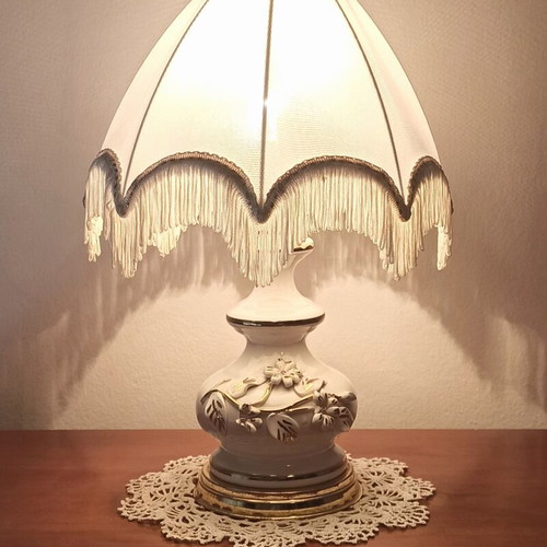 Vintage porcelain table lamp with fabric white shade and fringes used