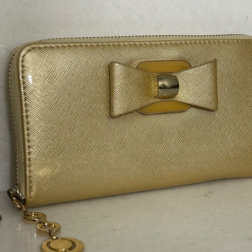 Two gold wallets, one with wrist strap