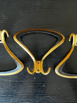 3 gold metal wall hooks