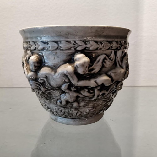 Faience cachepot used with embossed cherub design