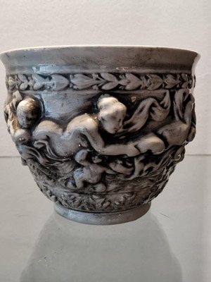 Faience cachepot used with embossed cherub design