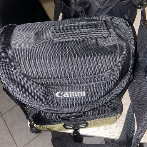 Canon EOS 1200D camera kit with lenses, memory card, battery, charger, and carrying bag