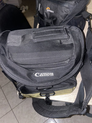 Canon EOS 1200D camera kit with lenses, memory card, battery, charger, and carrying bag