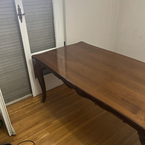 Wooden dining table used with carved legs and metal details
