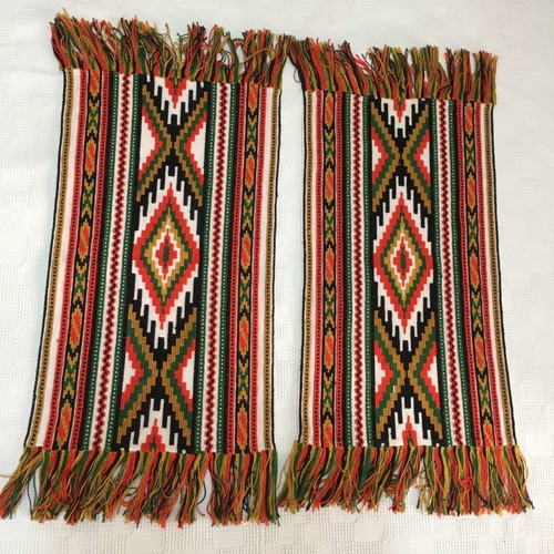 Set of handmade cross-stitch table runners with geometric patterns