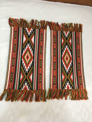 Set of handmade cross-stitch table runners with geometric patterns