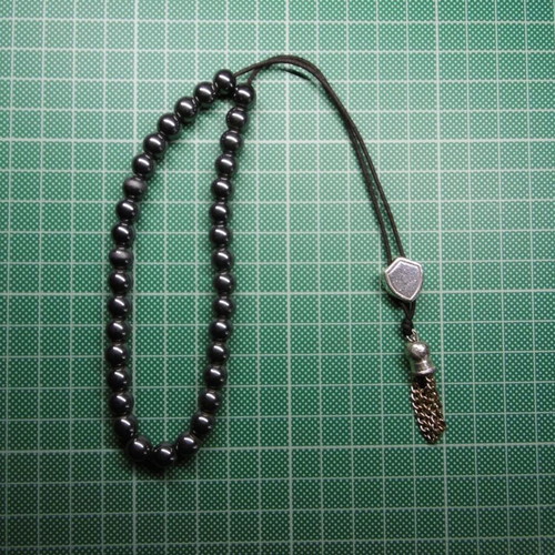 Handmade komboloi with 33 hematite beads, silver shield and metal tassel