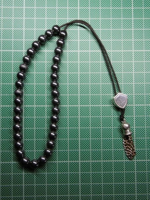 Handmade komboloi with 33 hematite beads, silver shield and metal tassel
