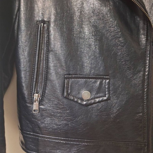 Only black biker jacket made of faux leather with silver details used