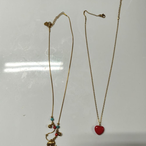 Two stainless steel necklaces like new, red and gold