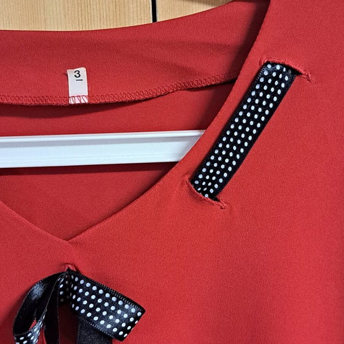 Women's elegant red blouse with black and white ribbon