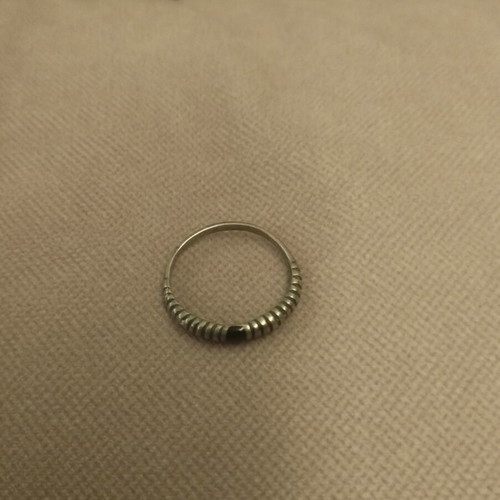 Silver ring with embossed ribbed design used
