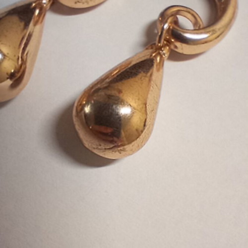 Teardrop gold earrings used with spiral hook design