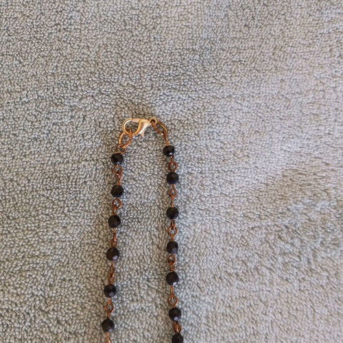 Rosary-style necklace like new with black beads and silver pendant