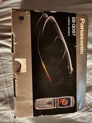 Panasonic EB-GD87 mobile phone used with box and charger needing repair